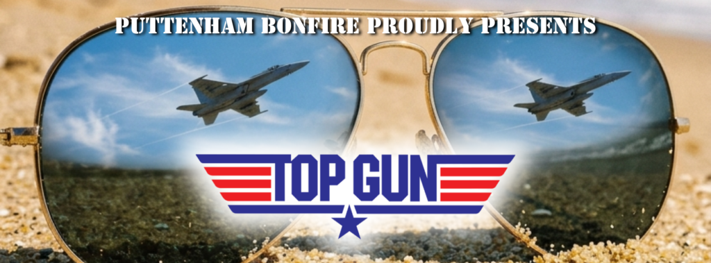 Puttenham Bonfire proudly presents TOP GUN. Image shows a pair of aviator sunglasses on a sandy beach with a reflection of a fighter jet passing close by with the TOP GUN logo on the image.